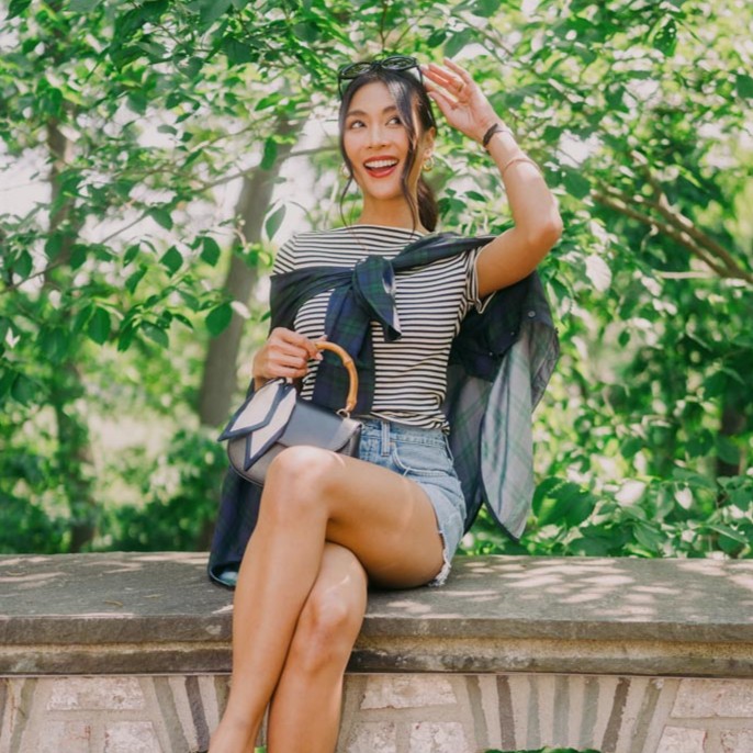 Woman sitting on a bench with an excited expression